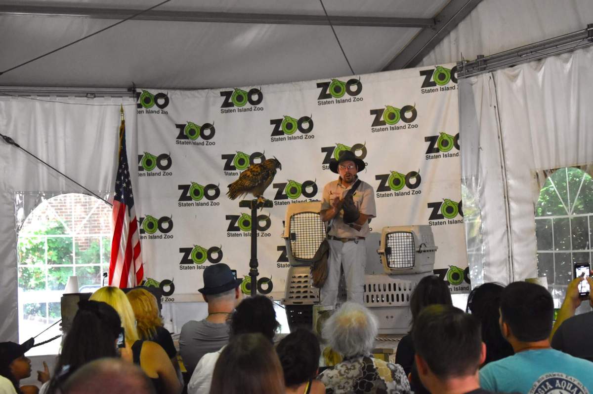 Man with a raptor in front of audience at the Staten Island Zoo