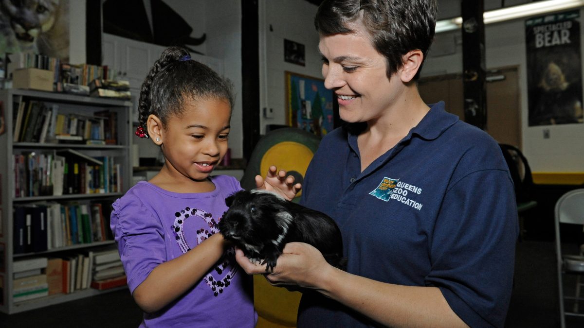 Toddler Time Child and Instructor with Guinea Pig