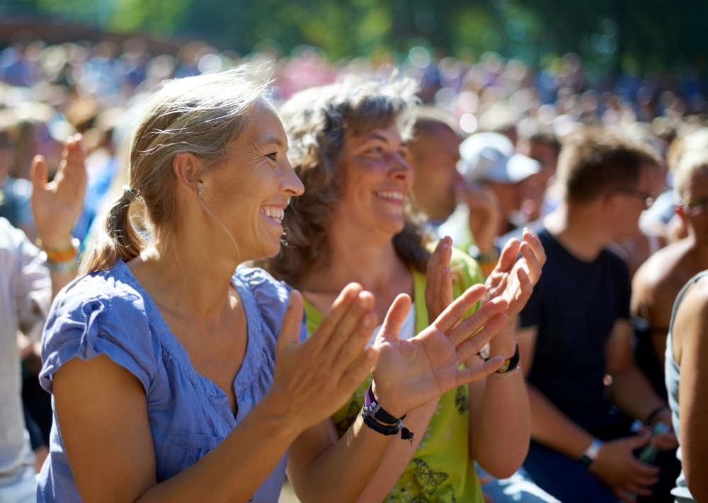 Enjoying,The,Festival,Vibe.,Two,Mature,Woman,Sitting,Outdoors,At
