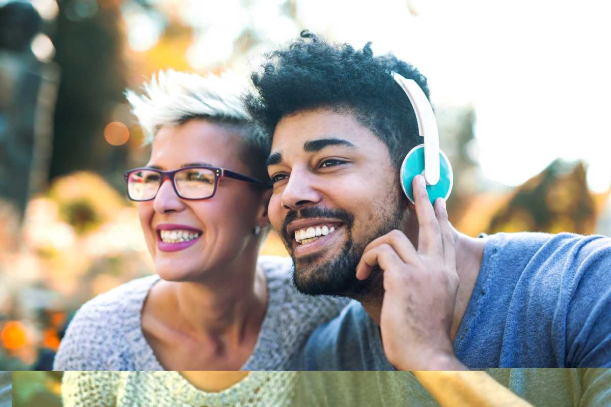 Mixed race couple listening to music on headphones