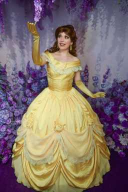 Woman in yellow ball gown portraying Bell from "Beauty and the Beast".