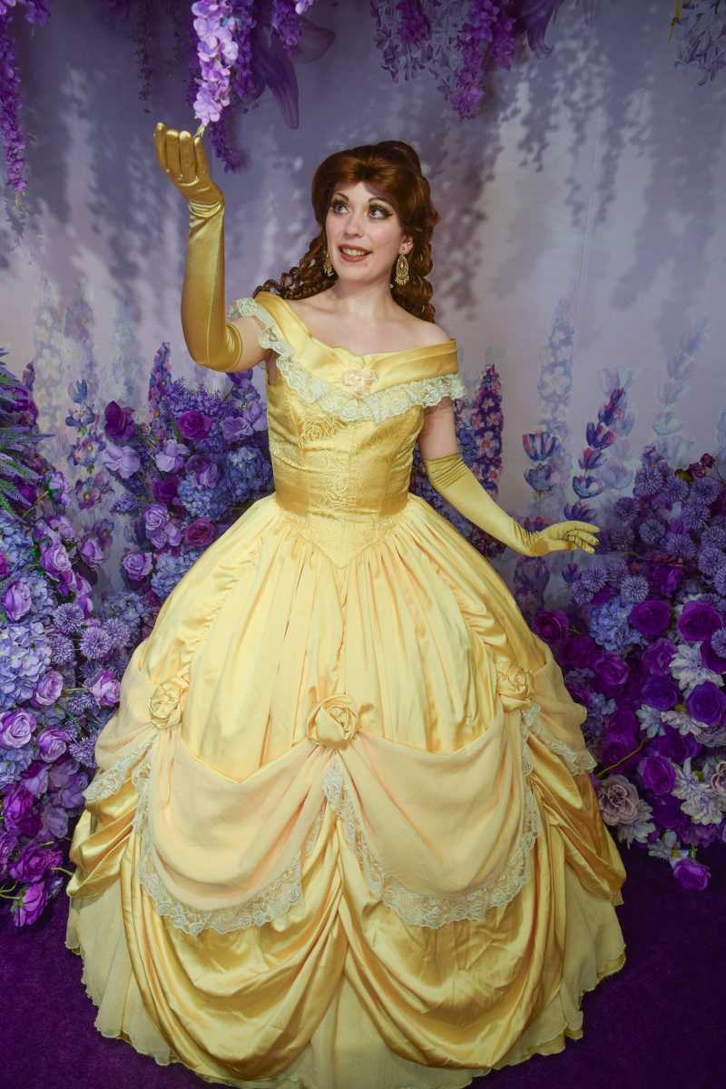 Woman in yellow ball gown portraying Bell from "Beauty and the Beast".