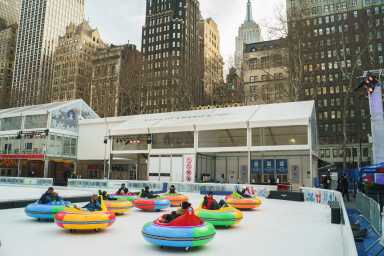 People enjoy Bumper Cars on Ice at Bryant Park’s Winter Village.